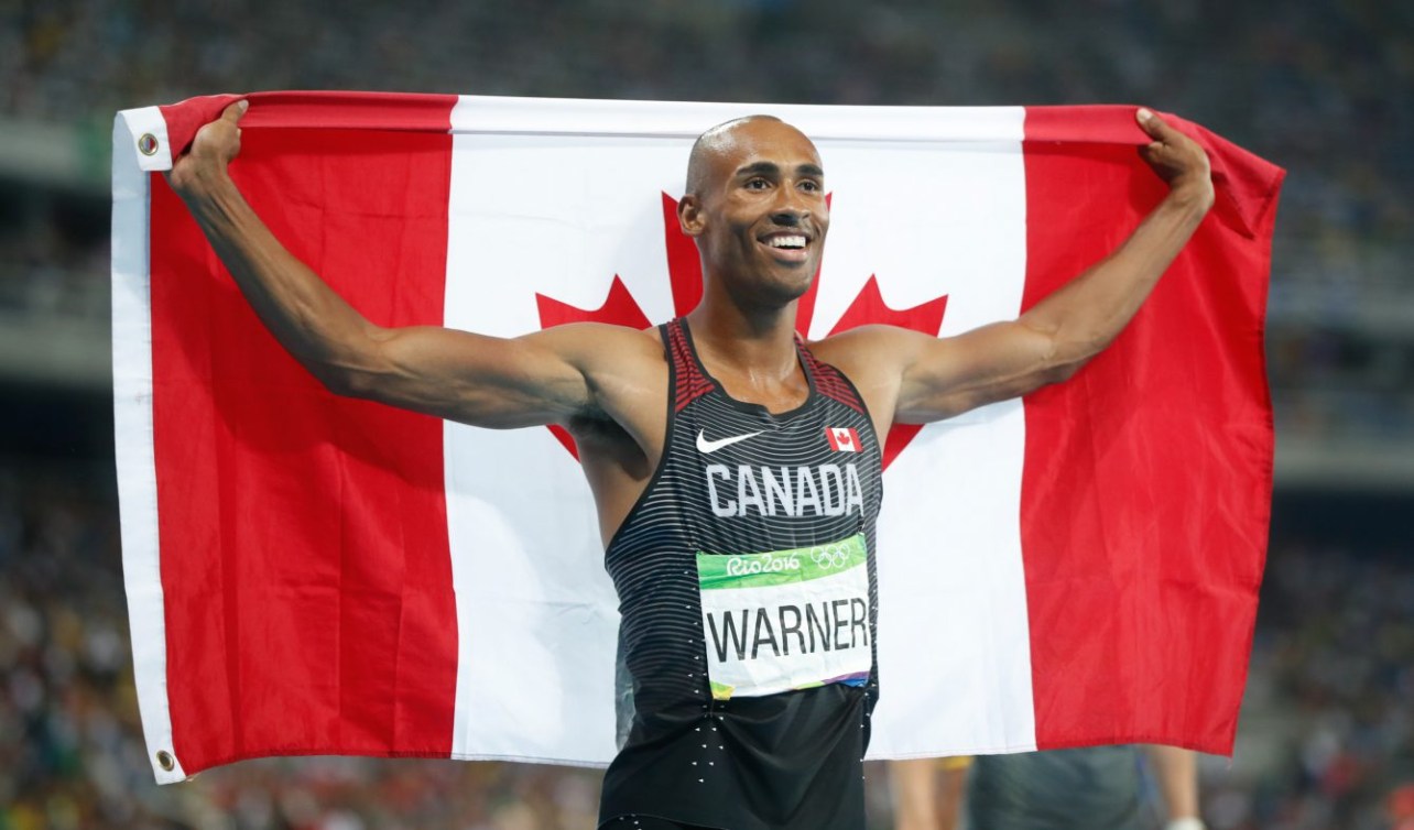 Damian Warner tenant le drapeau canadien