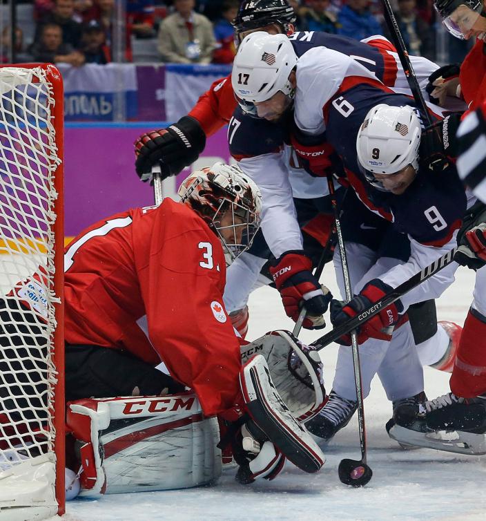 Carey Price (31) arrête la rondelle de Zach Parise (9) lors du match de demi-finale du tournoi olympique de Sotchi, le 21 février 2014. (AP Photo/Julio Cortez)